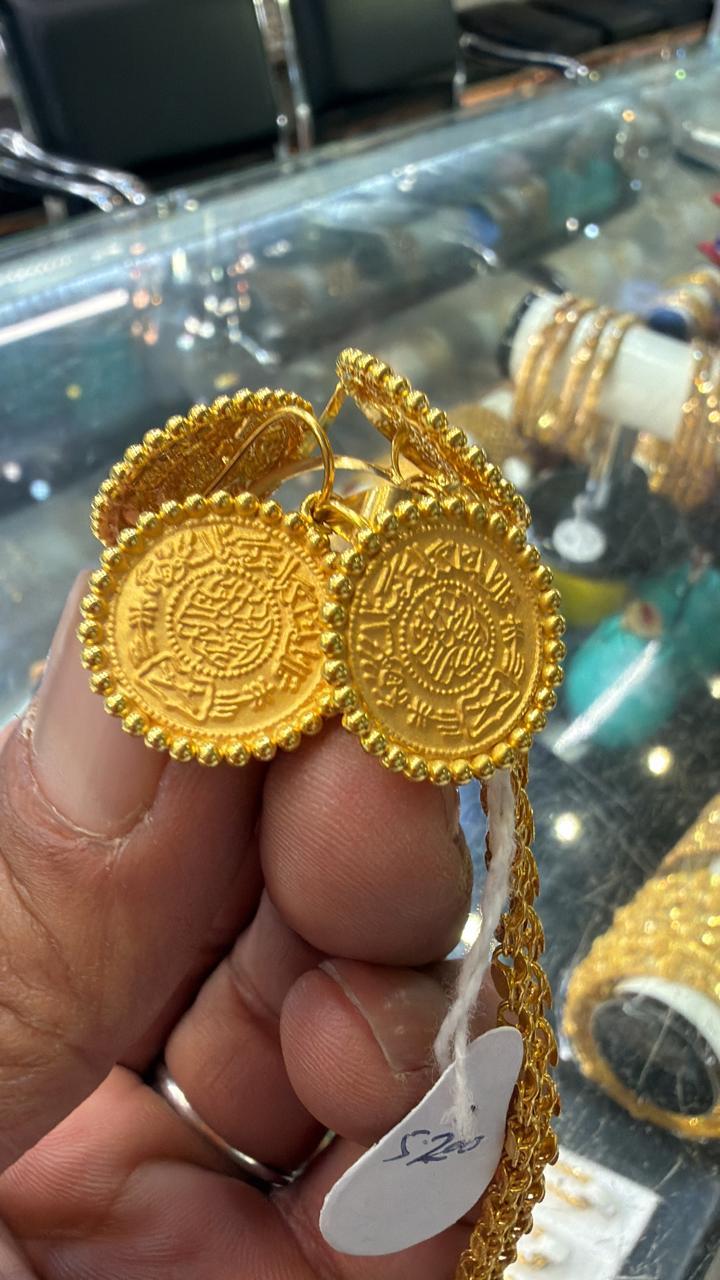 Traditional gold rings with detailed round faces